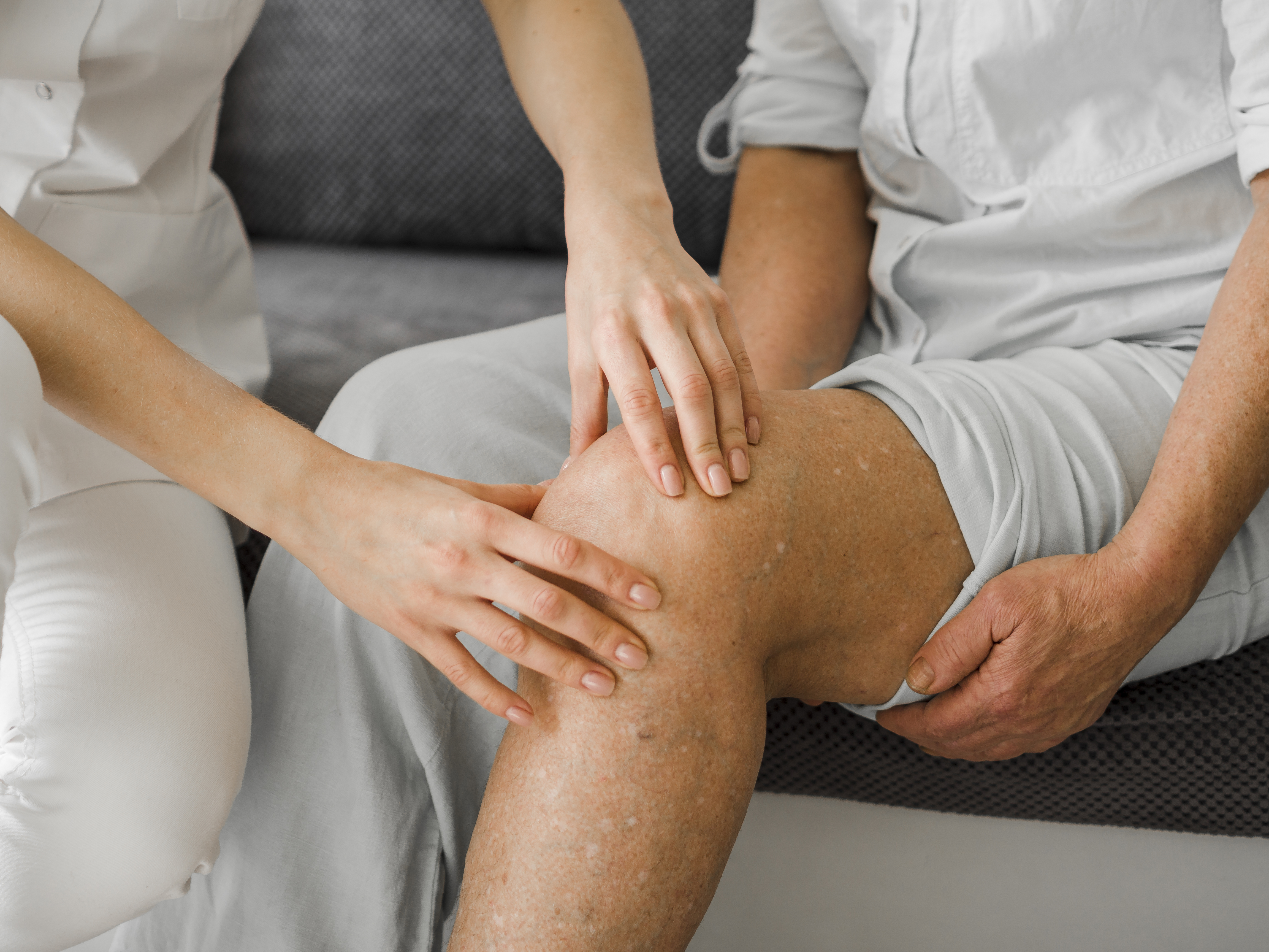 A physiotherapist assessing a patient's knee